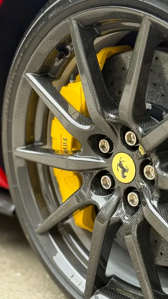 Close-up of a clean Ferrari 296 wheel with yellow brake caliper