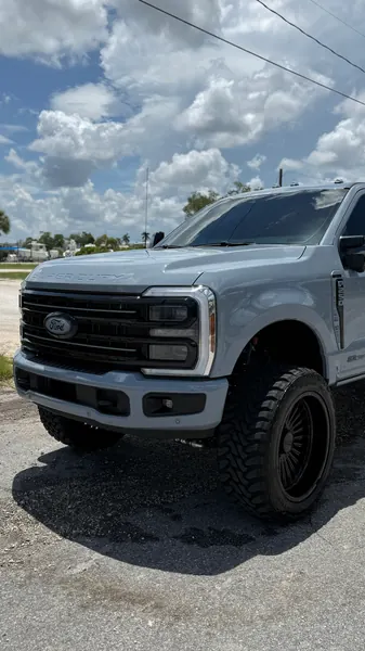 Silver lifted Ford Super Duty pickup truck