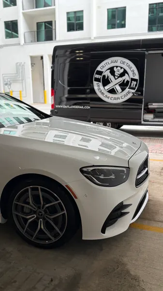 White Mercedes-Benz with the Outlaw Detailing mobile van behind it, ceramic coating client in Sarasota