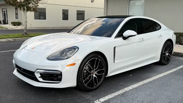 White Porsche Panamera in a parking lot, ceramic coating client in Sarasota